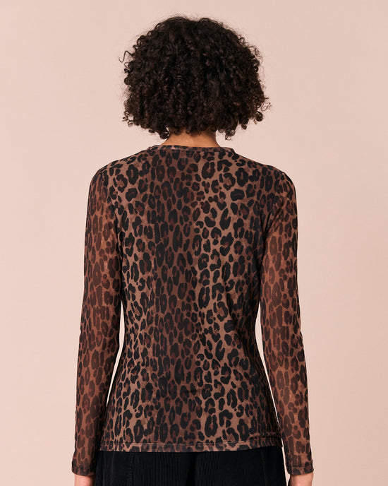 model wears dark leopard mesh top