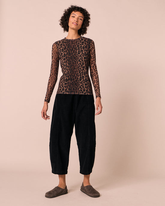model wears dark leopard mesh top