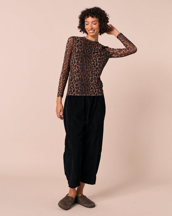 model wears dark leopard mesh top