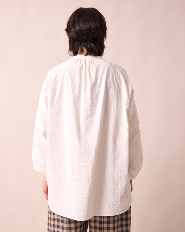 model wears mia white cotton shirt