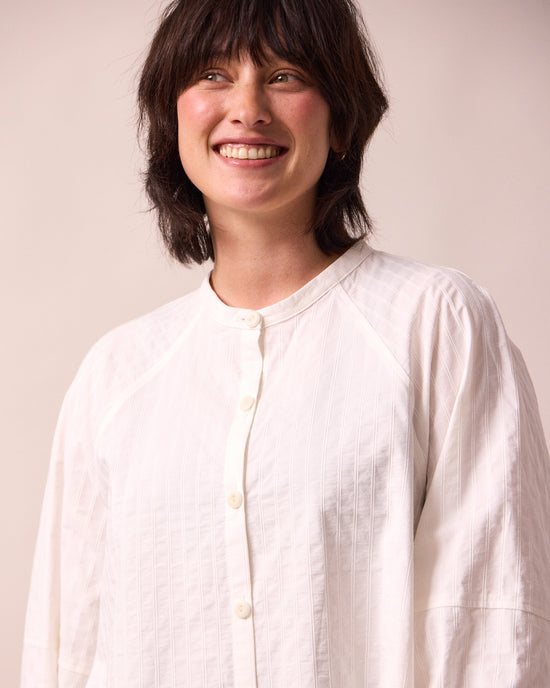 model wears mia white cotton shirt