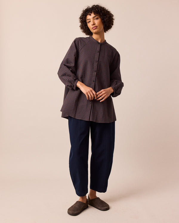 model wears mia chocolate and navy seersucker shirt