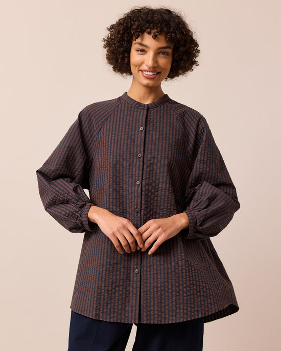 model wears mia chocolate and navy seersucker shirt