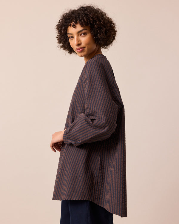 model wears mia chocolate and navy seersucker shirt