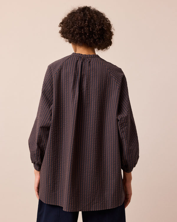 model wears mia chocolate and navy seersucker shirt