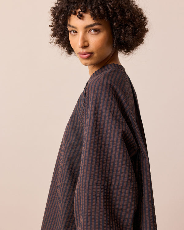 model wears mia chocolate and navy seersucker shirt