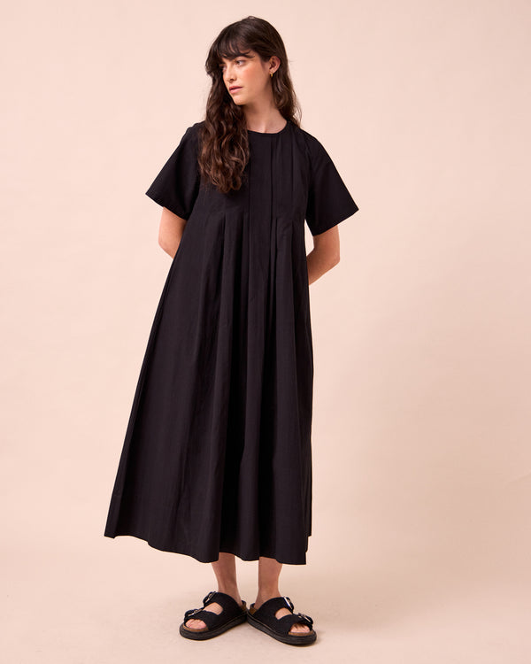 model wears mica black cotton dress