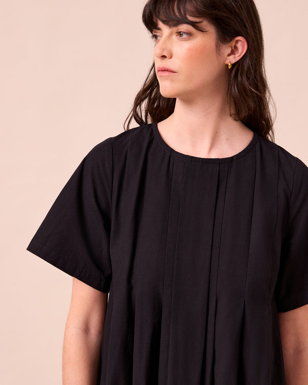 model wears mica black cotton dress