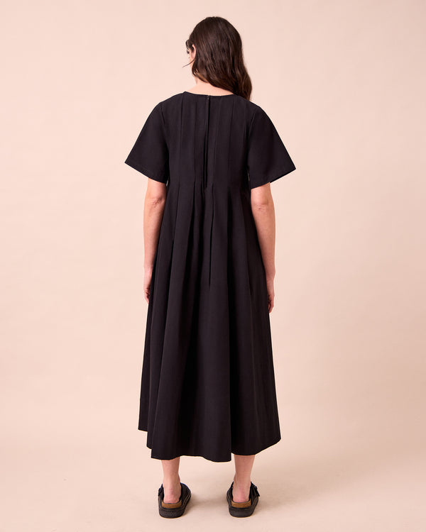 model wears mica black cotton dress