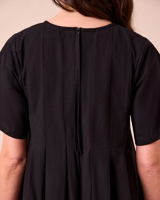 model wears mica black cotton dress