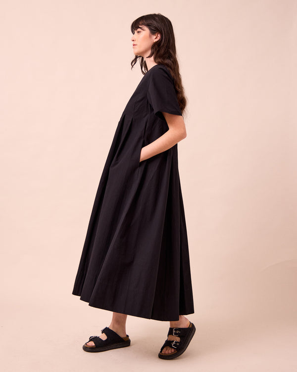 model wears mica black cotton dress