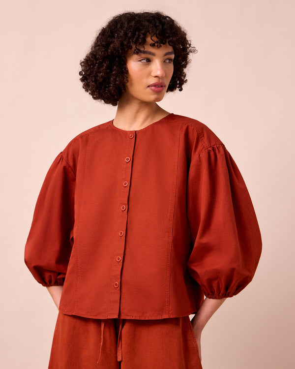model wears miley paprika cotton linen top