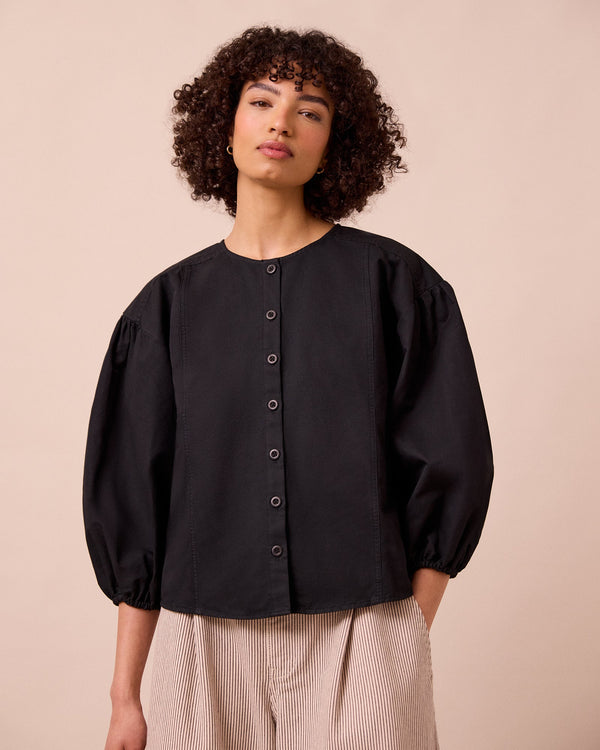 model wears miley washed black cotton linen top