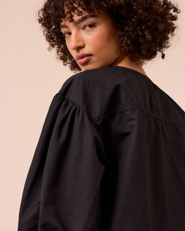 model wears miley washed black cotton linen top