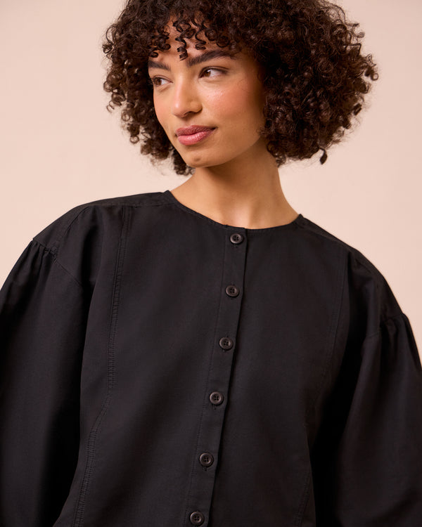 model wears miley washed black cotton linen top