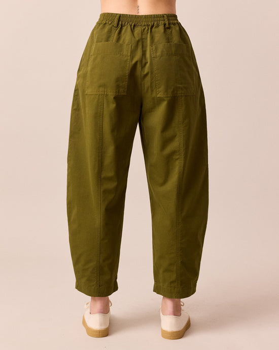 model wears millie dark olive cotton trousers back