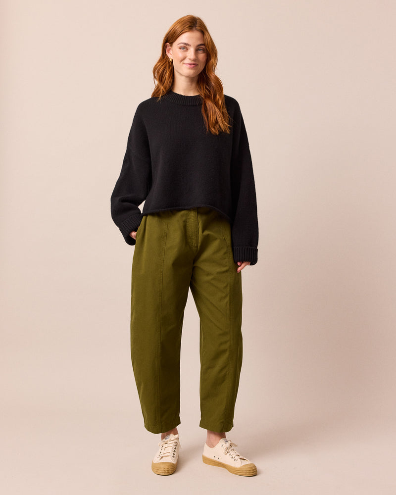 model wears millie dark olive cotton trousers left