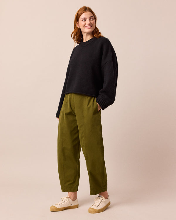 model wears millie dark olive cotton trousers right