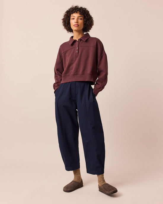 model wears millie navy cotton trousers left