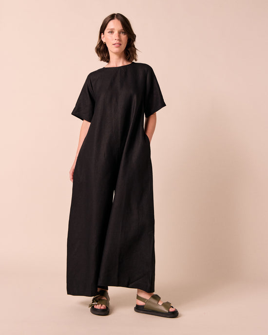 model wears molly black linen jumpsuit