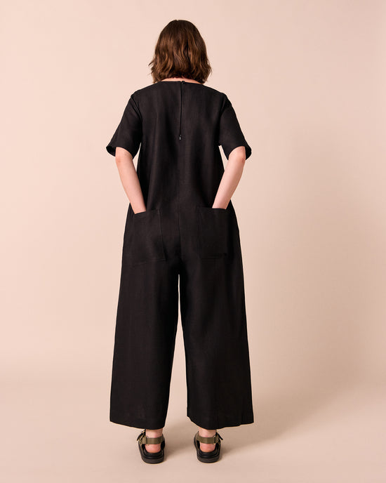 model wears molly black linen jumpsuit