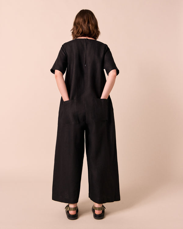 model wears molly black linen jumpsuit