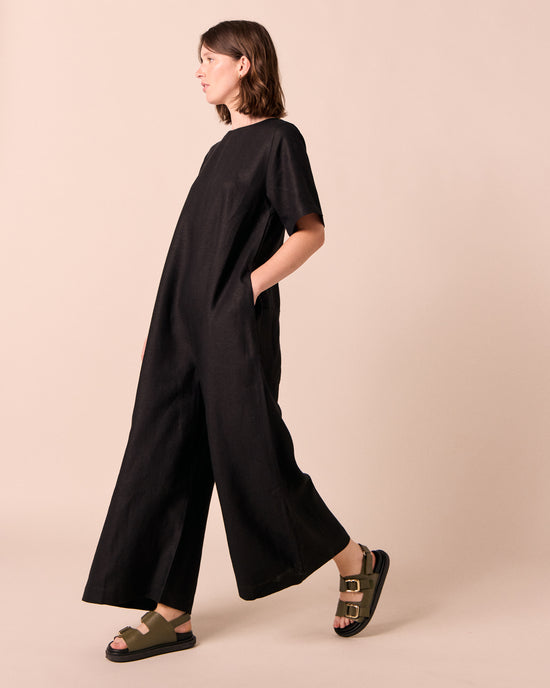 model wears molly black linen jumpsuit