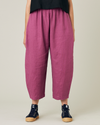 model wears dahlia pink linen mabel trousers