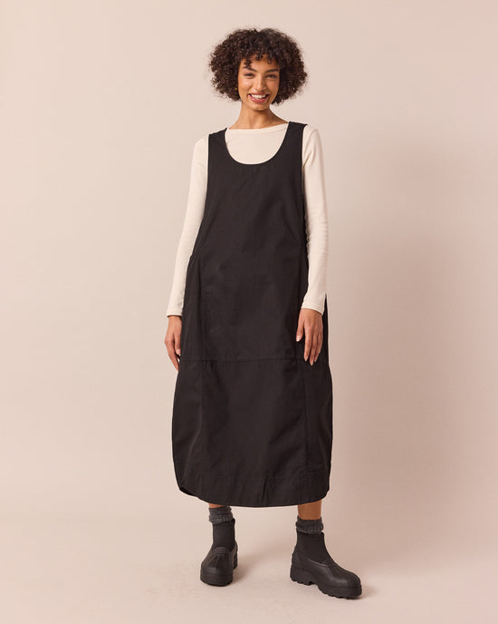 model wears naima black cotton dress