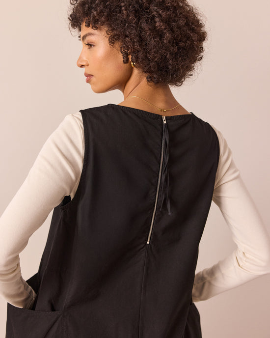 model wears naima black cotton dress