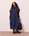 model wears naima mid blue denim dress