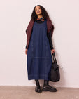 model wears naima mid blue denim dress