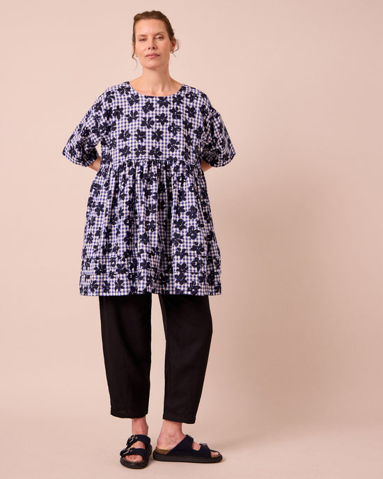 model wears neve floral stamped gingham linen dress