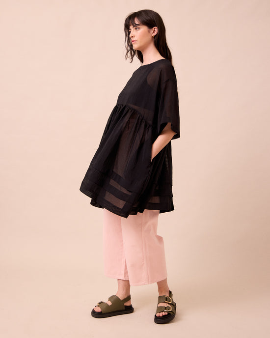 model wears neve black sheer stripe dress