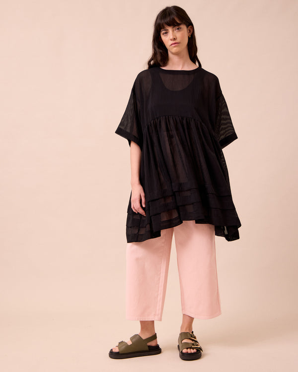 model wears neve black sheer stripe dress