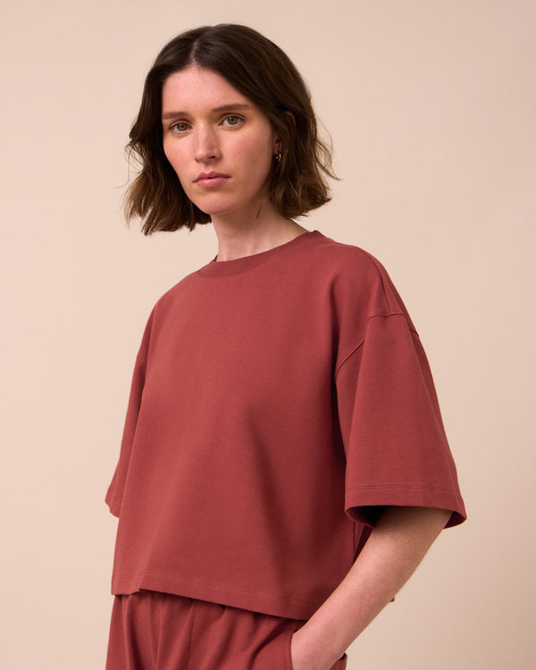 model wears nicole brick jersey top