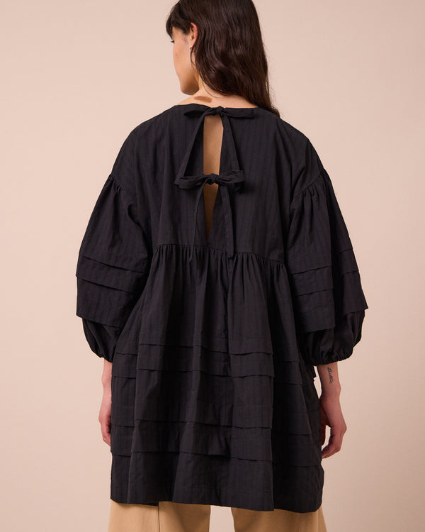 model wears nine black self stripe dress