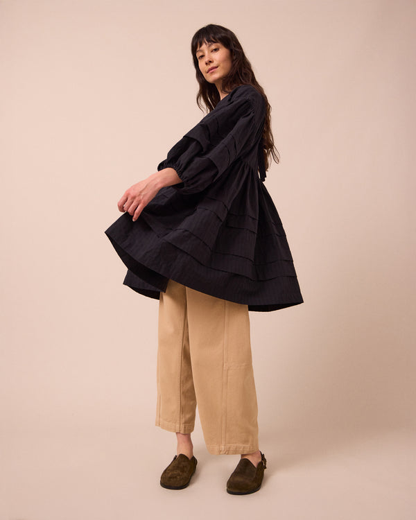 model wears nine black self stripe dress