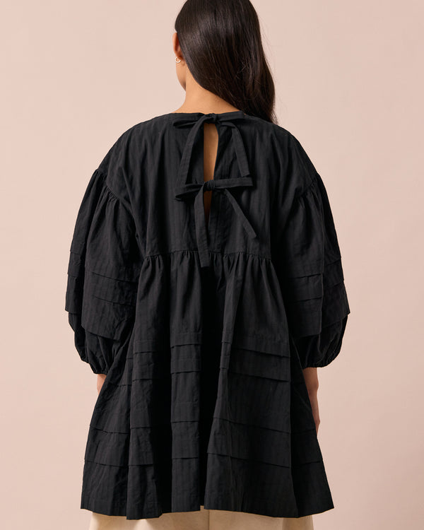 model wears nina black self stripe cotton dress