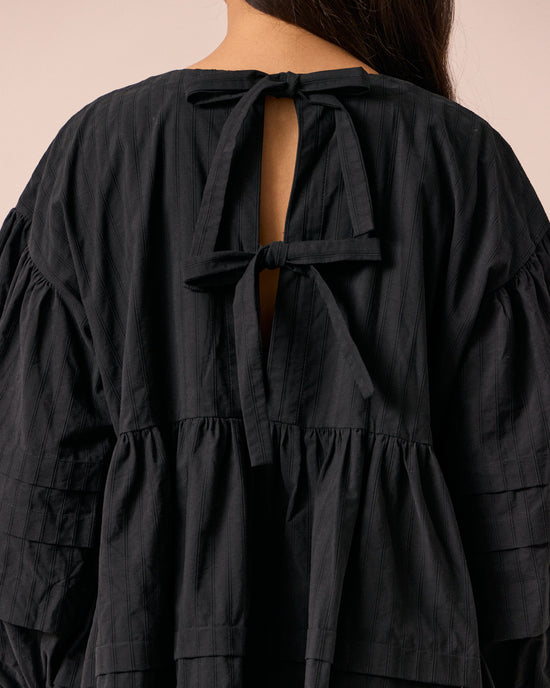 model wears nina black self stripe cotton dress
