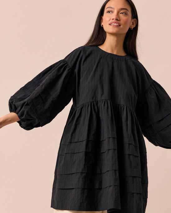 model wears nina black self stripe cotton dress