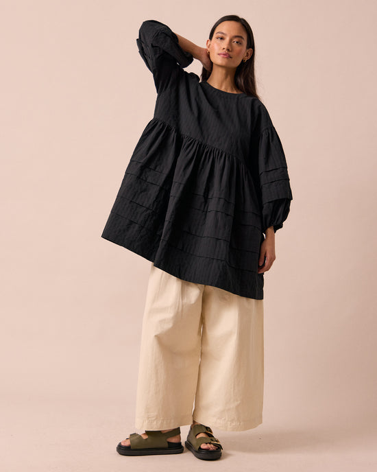 model wears nina black self stripe cotton dress