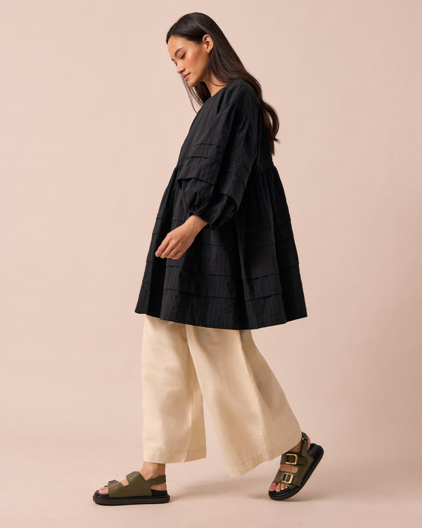 model wears nina black self stripe cotton dress