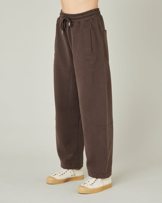 model wears chocolate jersey madi trousers left