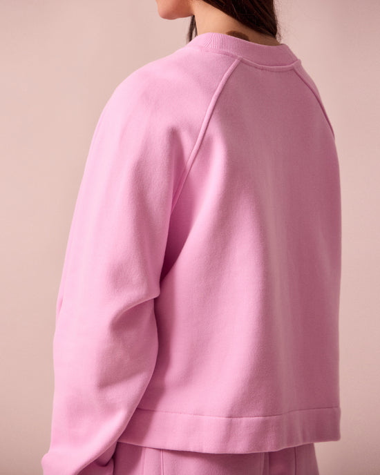 model wears noa orchid pink fleeceback jersey jumper