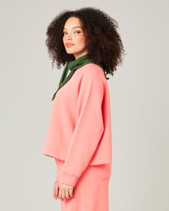 model wears shrimp pink noa jumper 