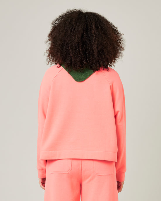 model wears shrimp pink noa jumper 