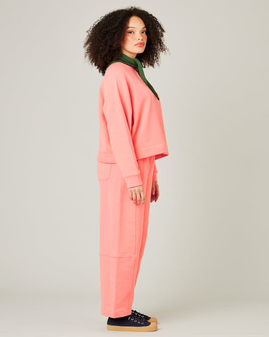 model wears shrimp pink madi trousers 