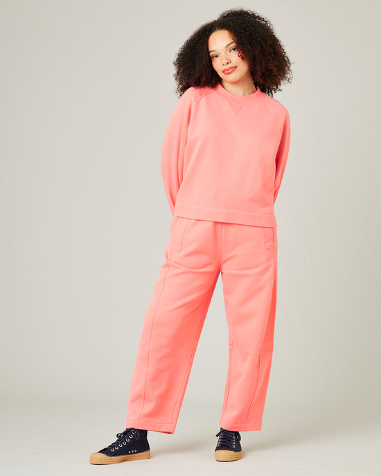 model wears shrimp pink madi trousers 