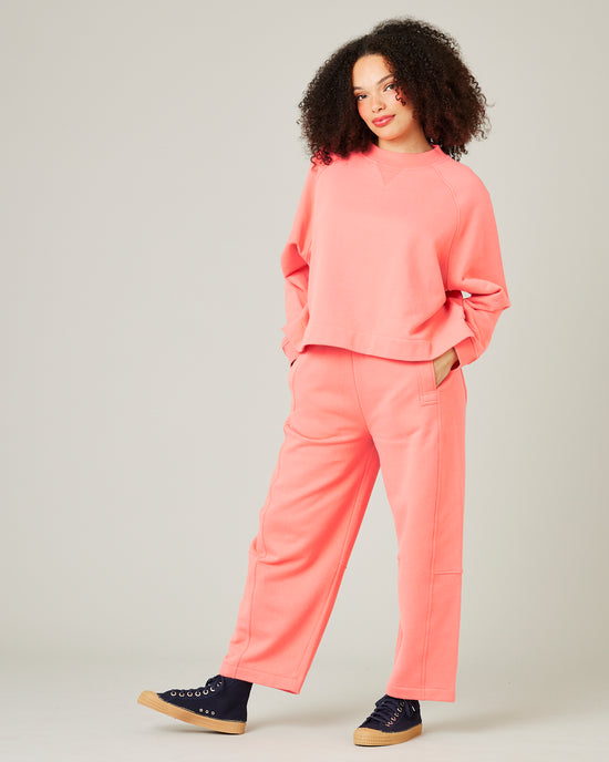 model wears shrimp pink madi trousers 